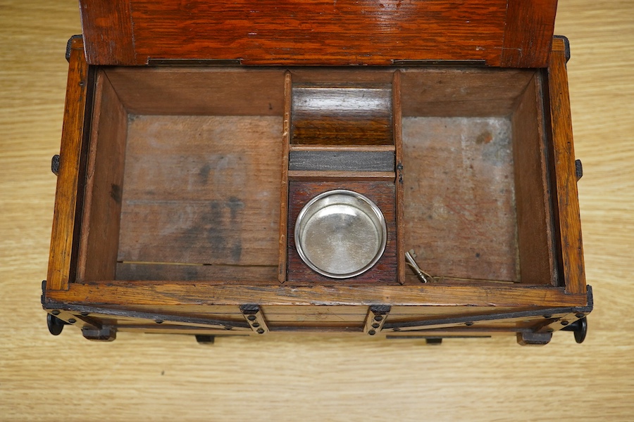 A late 19th or early 20th century novelty cigar box in the form of a railway coal wagon in Great Eastern Railway livery, of oak construction with sectioned interior, integrated match striker, and dummy coal load hiding t